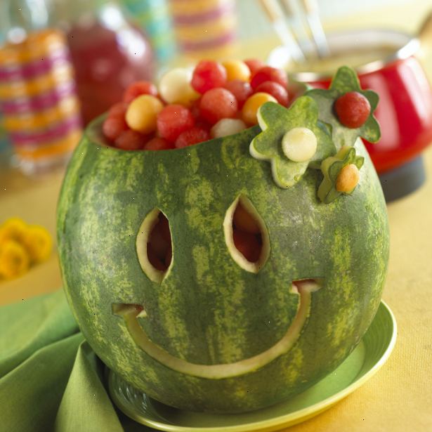 Hur man skära ett leende på en vattenmelon. Använd kniven för att ta bort den övre delen av vattenmelon att skapa blommorna med en blomma cookie cutter.